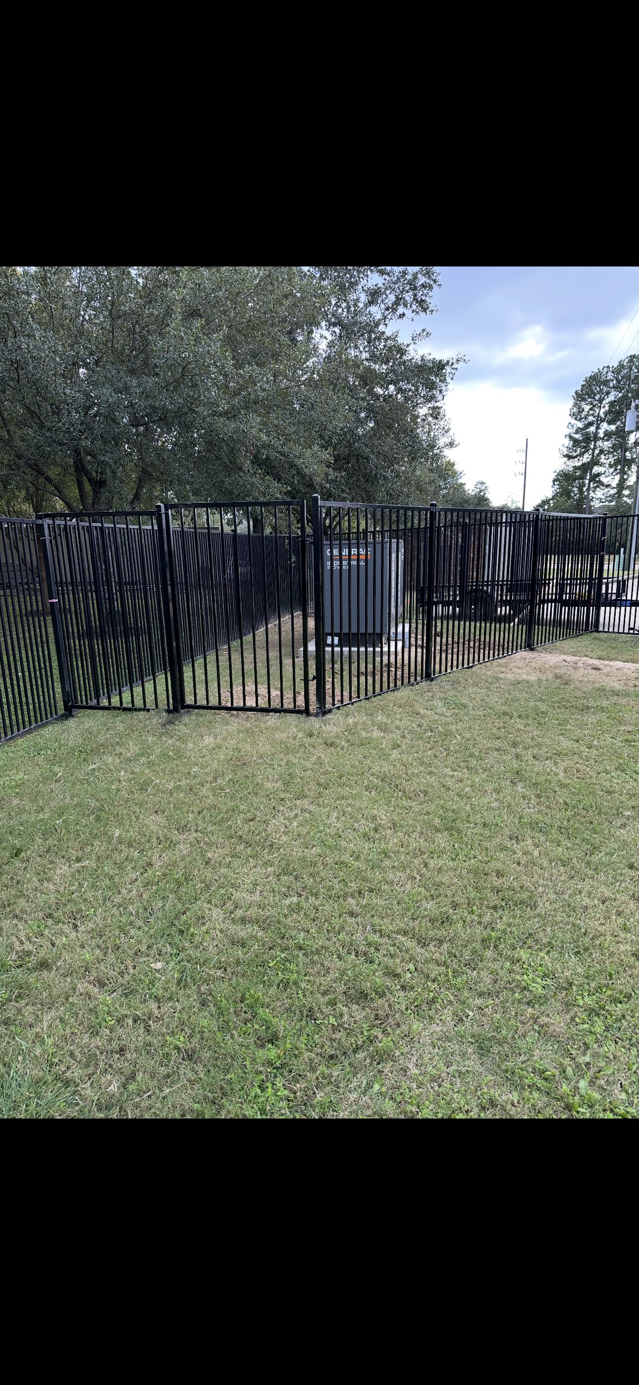Steel fence and gate around equipment enclosure